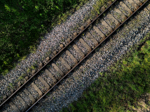 fly over train tracks in the countryside. vertical view of the landscape. background, texture modellers, transport journalists theme. background from above video fly over train tracks in the countryside. vertical view of the landscape. background, texture modellers, transport journalists theme. background from above video, sleeper, tie, railroad track concrete railway sleeper thoroughfare stock pictures, royalty-free photos & images