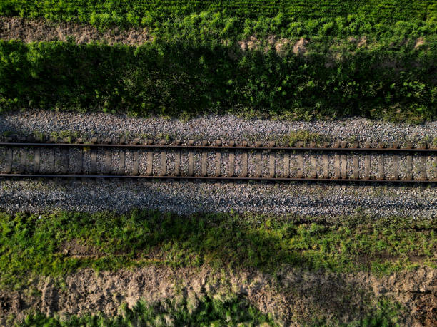 fly over train tracks in the countryside. vertical view of the landscape. background, texture modellers, transport journalists theme. background from above video fly over train tracks in the countryside. vertical view of the landscape. background, texture modellers, transport journalists theme. background from above video, sleeper, tie, railroad track concrete railway sleeper thoroughfare stock pictures, royalty-free photos & images