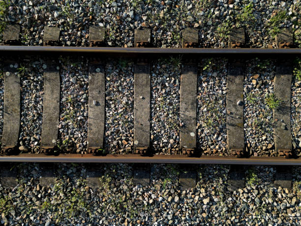 fly over train tracks in the countryside. vertical view of the landscape. background, texture modellers, transport journalists theme. background from above video fly over train tracks in the countryside. vertical view of the landscape. background, texture modellers, transport journalists theme. background from above video, sleeper, tie, railroad track concrete railway sleeper thoroughfare stock pictures, royalty-free photos & images