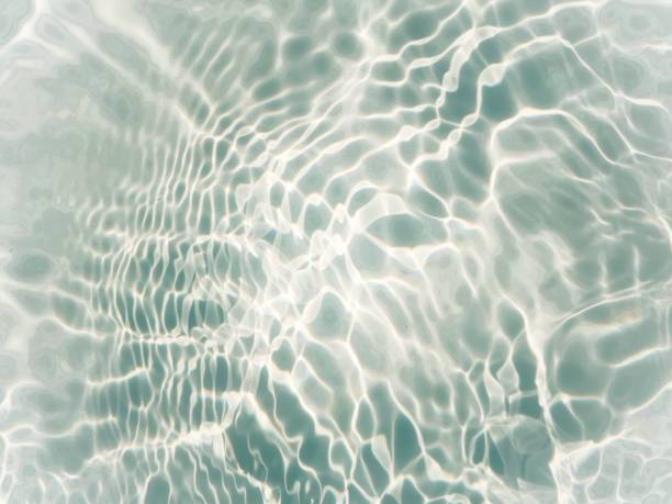 istock Blue water with ripples on the surface. Defocus blurred transparent blue colored clear calm water surface texture with splashes and bubbles. Water waves with shining pattern texture background. 1485976592