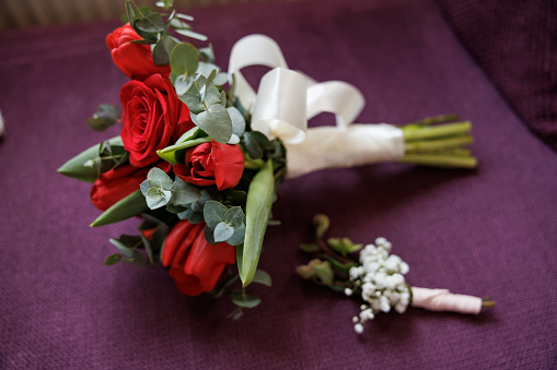 Bouquet of artificial red roses, isolated, space for copy in the side.