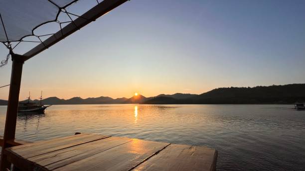 istock Sunrise over hill with a ship at Labuan Bajo 1485979157