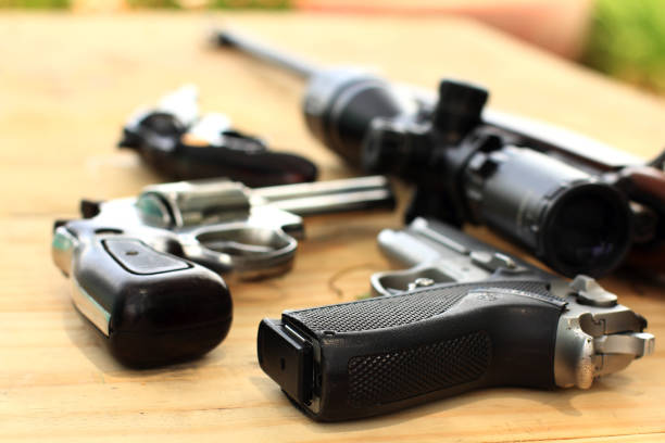 istock Semi-automatic pistol and ammunition placed on wooden table,Preparing equipment for hunting and sporting 1485981447