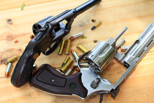 Semi-automatic pistol and ammunition placed on wooden table,Preparing equipment for hunting and sporting.