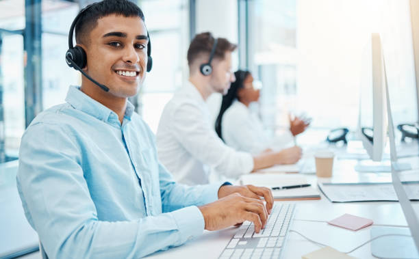 istock Sales man, call center agent and customer service support operator giving advice, help and expert communication while working in office. Portrait of young consultant, crm telemarketing and contact us 1485983130