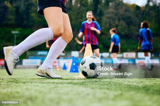 Close Up Of Female Player Exercising With Ball On Soccer Training At The Stadium Stock Photo - Download Image Now