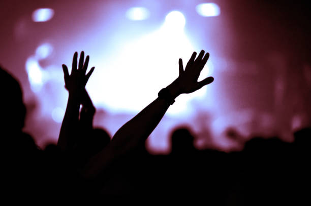 istock Crowd at a music concert, audience raising hands up 1485984557