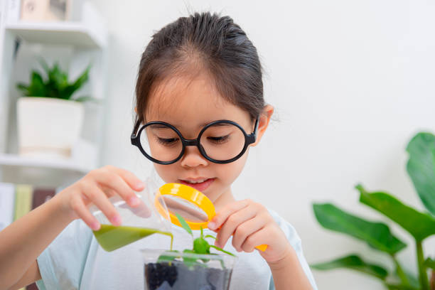 Asia little Girl in biology class learning about plants