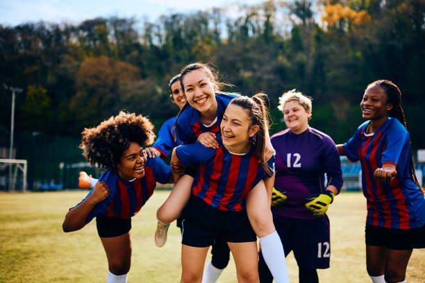 istock Multiracial women's soccer team having fun and celebrating after a victory. 1485987301