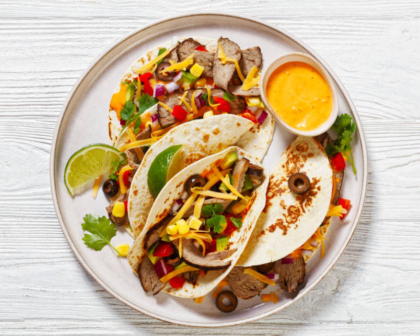istock Beef Steak Tacos with veggies, avocado, corn 1485987341