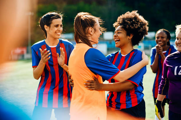 istock Women's soccer team having fun after successful game on playing field. 1485987440