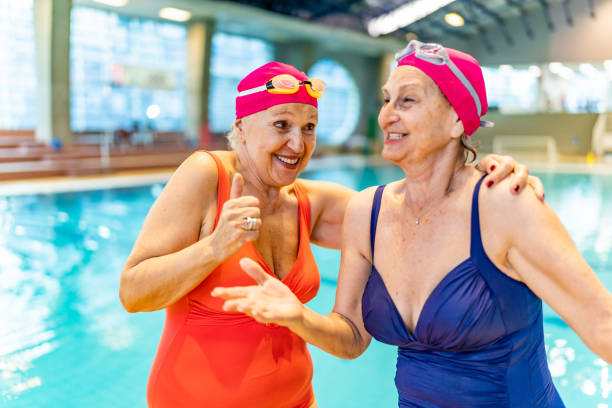 istock Senior Friends Having Fun At Swimming Pool. 1485989687