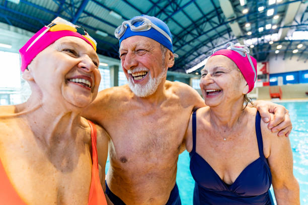istock Group of senior friends hugging indoors. 1485990015