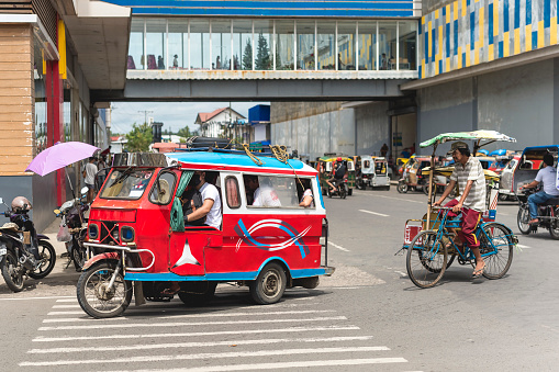 Calbayog, Samar, Philippines - Sept 2022: A motorela, a variant of a tricycle transporting passengers in the city.