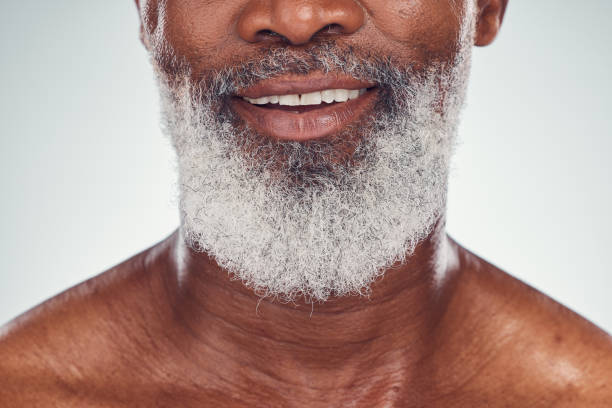 istock Smile, beard and face with a senior black man grooming in studio on a gray background for beauty or skincare. Skin, hygiene and cosmetics with a mature male indoor to promote facial hair maintenance 1485993870