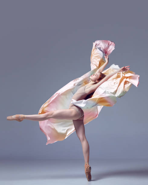 istock Charming ballerina dancing graceful movement with fabric over grey studio background. Gorgeous silhouette 1485995993