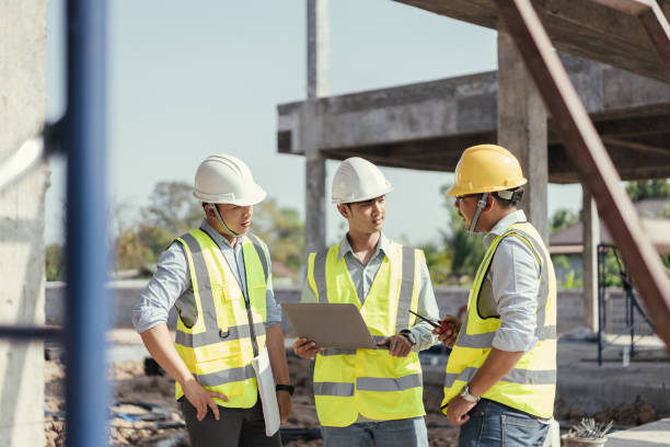 istock Civil engineer use computer labtop and discussing plan details in construction site. Building project with Civil Engineer,. 1485996641