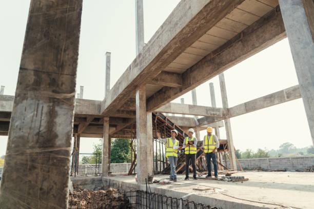 istock Civil Engineer, Contractor and Architect discussing plan details in construction site. 1485996798