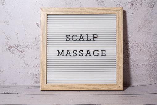 Letter board SCALP MASSAGE text. Hair growing routine. Wellness wellbeing concept Anti stress Medicine and cosmetology. SPA treatment