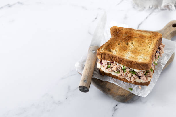 istock Tuna sandwich with mayo and vegetables on white marble 1485998522
