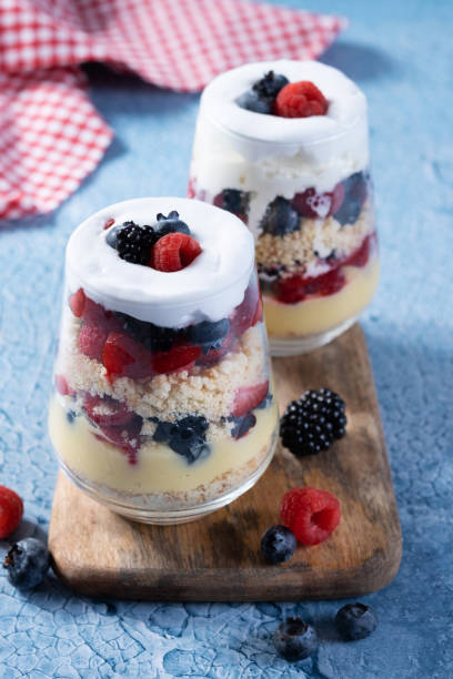 istock Trifle dessert with berries and cream on blue background 1486000323