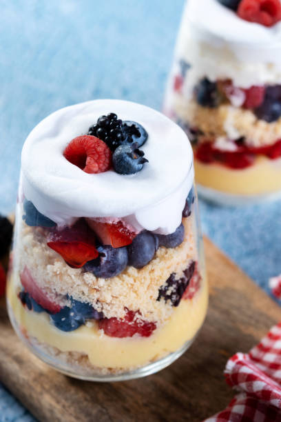 istock Trifle dessert with berries and cream on blue background 1486000396