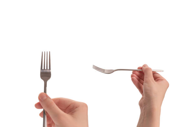 istock Fork in woman hand isolated on white. 1486003995