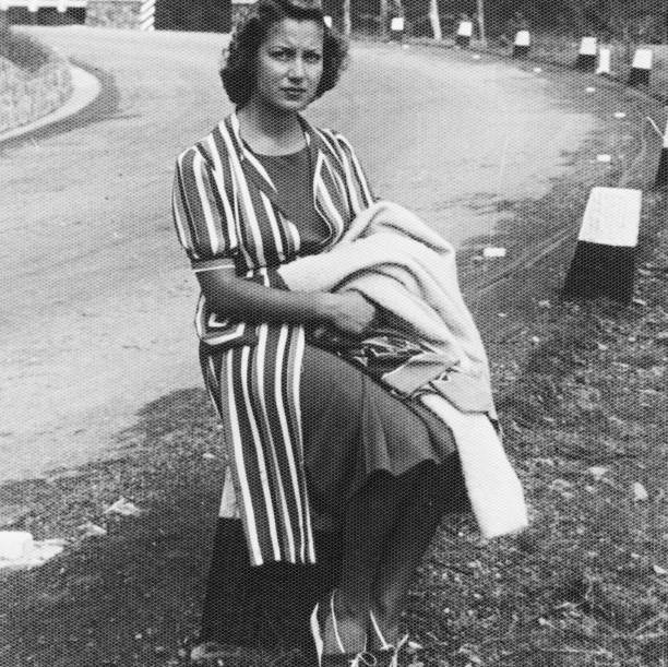 istock Young Woman sitting on roadside in 1938. 1486006803