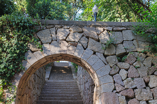 Barcelona, Spain - august 2022: Masonry Archway and Staircase inside Montjuic Garden Public Park, Barcelona, Spain.