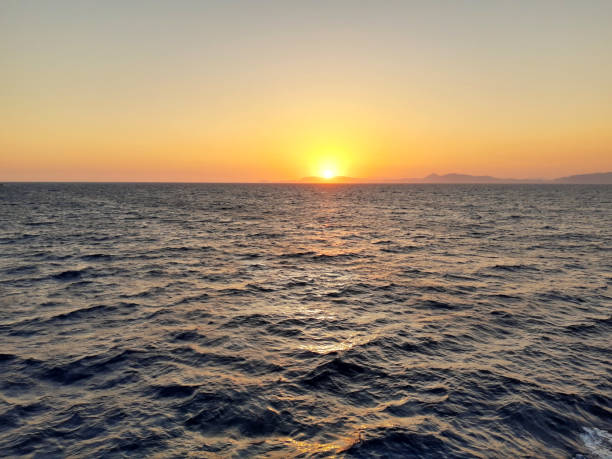 istock sunset over the wavy sea 1486010203