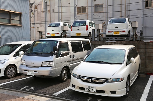 Nissan kei car, Honda and Suzuki cars parked in Tokyo, Japan. There are approximately 68.9 million cars registered in Japan.