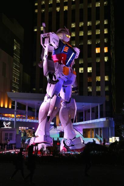 People visit Mobile Suit Gundam gigantic robot statue in Odaiba, Tokyo. The 18-meters-tall anime robot will be replaced by a bigger one in 2017.