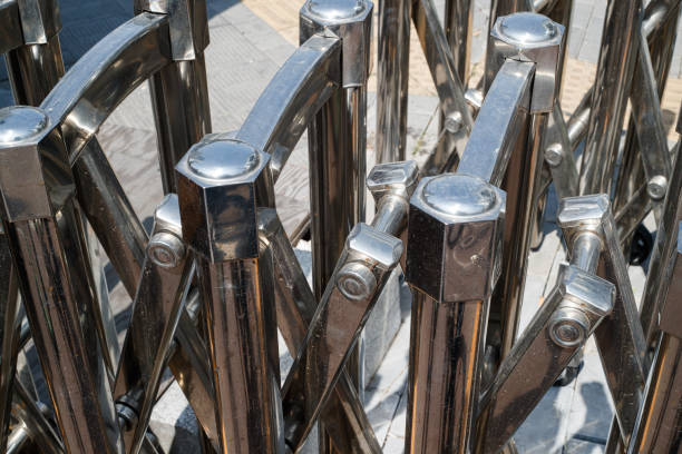 Man climbing up metal stepladder near brick wall, closeup