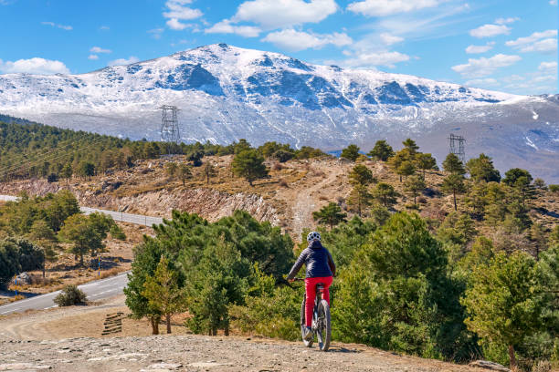 Woman with electric mountain bike in the Sierra Nevada, Andalosia, Spain stock photo