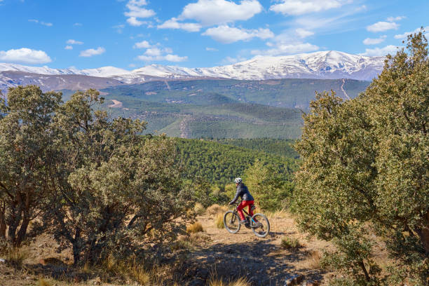Woman with electric mountain bike in the Sierra Nevada, Andalosia, Spain stock photo