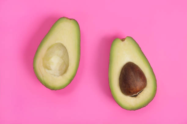 istock Raw ripe avocado on pink background, weight loss concept 1486013812