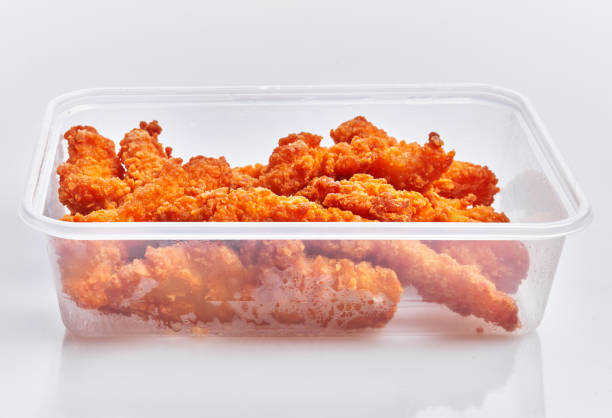 Delicious fried chicken on delivery plastic box over isolated white background