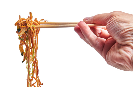 Hand of man holding thai noodles over isolated white background