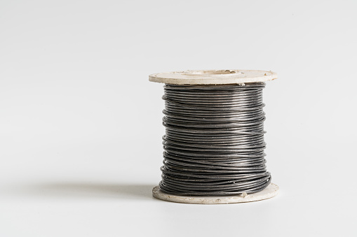 Spool of thread with needle isolated on white