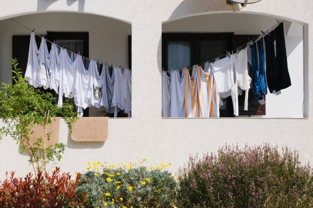 istock laundry hanging on a balcony clothesline on white house wall background 1486016440