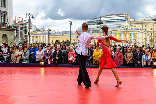 Moscow, Russia - September, 2017: Amateur dancers demonstrate their art of ballroom dancing on the central street of Moscow on City Day. Incendiary Latin American cha-cha.