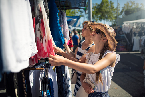 Mother and daughter tourists buying souvenirs on local flea market in Andalusia, Spain.  
Nikon D810