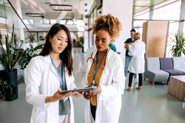 istock Female doctors talking in hospital corridor 1486019053