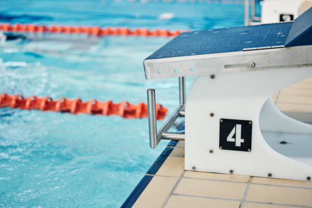 istock Sports, swimming pool and number on diving board for training, exercise and workout for triathlon competition. Fitness, motivation and four on professional podium for dive, marathon start and race 1486020246
