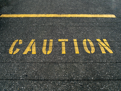 Warning text caution on ground