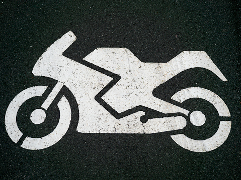 Motorcycle parking sign on ground