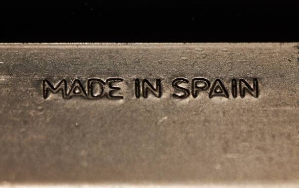 istock Closeup of a polished silver plate, engraved with the words 'Made in Spain' in a bold script 1486022582