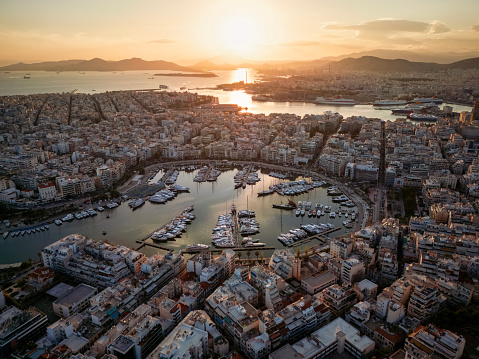 Aerial view of the popular Zea Marina in Piraeus, Athens, Greece, with lined up sailing boats and yachts during sunset time