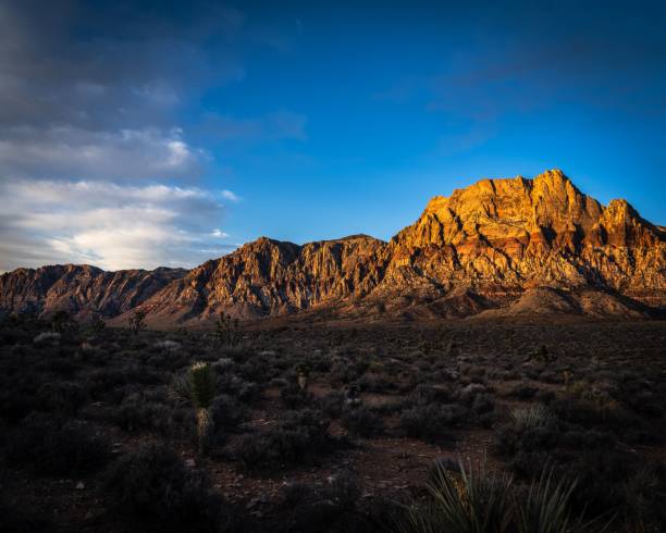 istock an arid desert with tall mountains in the distance and clouds 1486022932