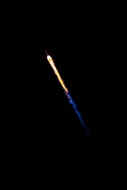 istock a space shuttle flying high up in the night sky with smoke coming from it 1486022993